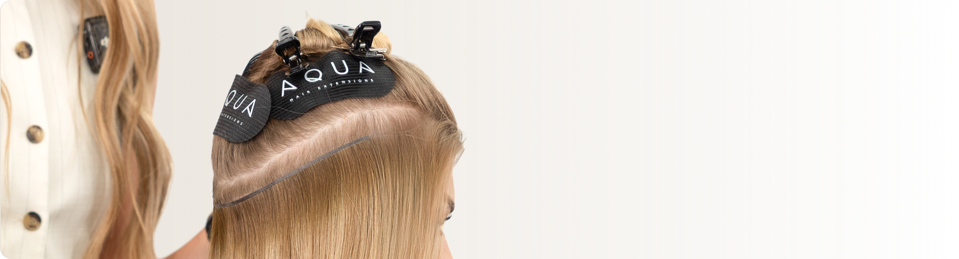 Expert stylist performing AQUA® Tape In application for pros – fast, flexible, and flawless weft install
